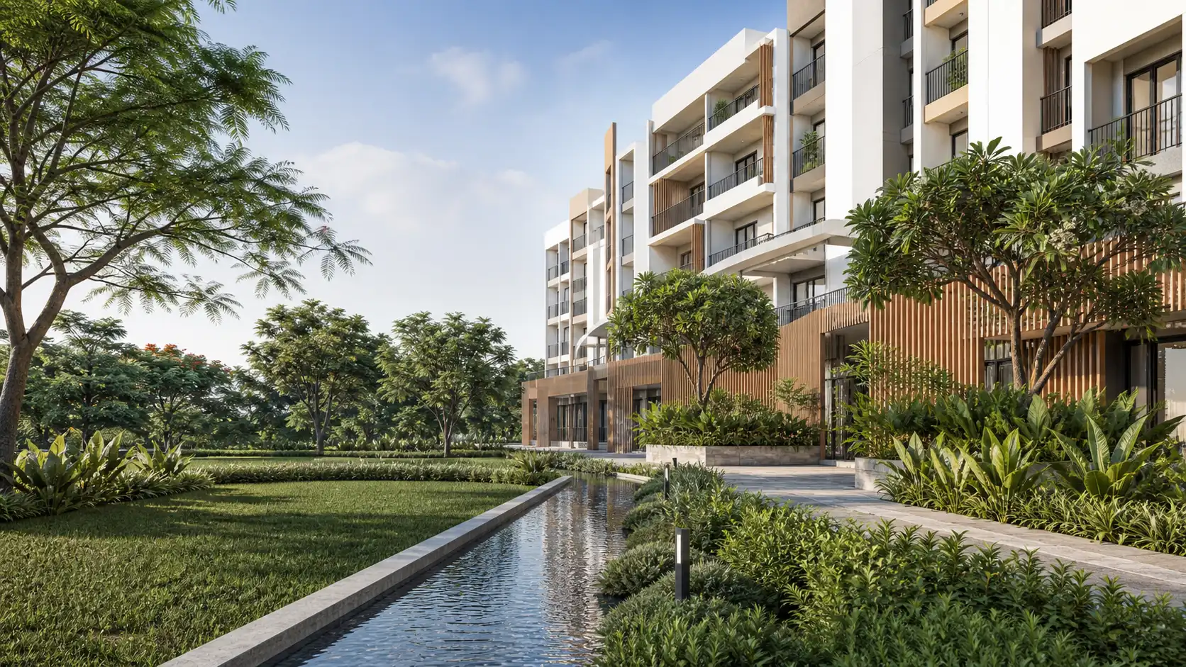 Contemporary light-coloured apartment building beside a landscaped lawn and narrow water rill